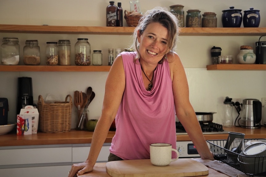 Emma Hohnen leans on a kitchen bench top.