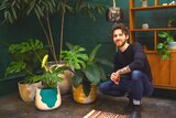 Plant stylist Ryan Klewer crouches beside various pots of plants, and shares tips on how to decorate home with indoor plants.