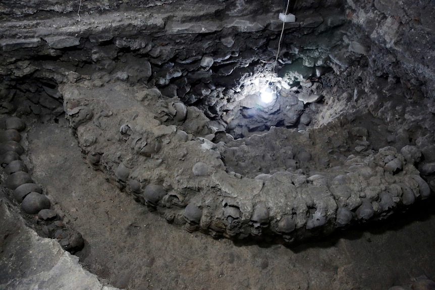 Skulls embedded in lime and stone are seen as part of a discovery of a cylindrical edifice uncovered under Mexico City.