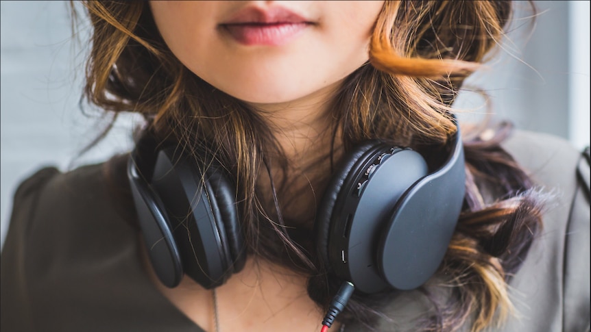 Girl wearing black headphones.