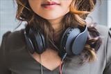 Girl wearing black headphones.