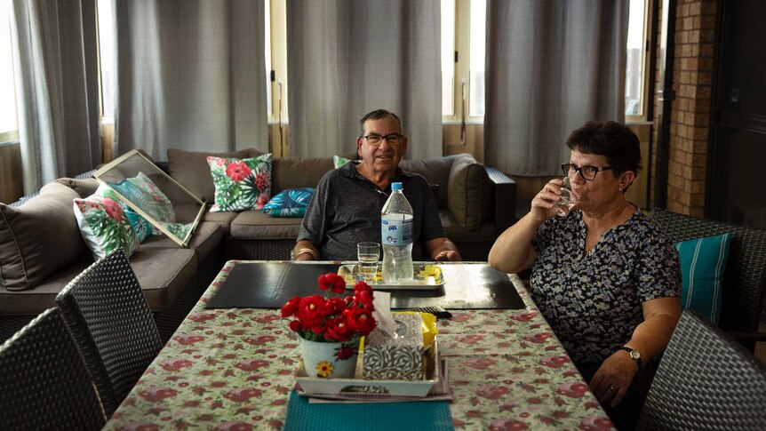 A man and a woman sitting at a table.