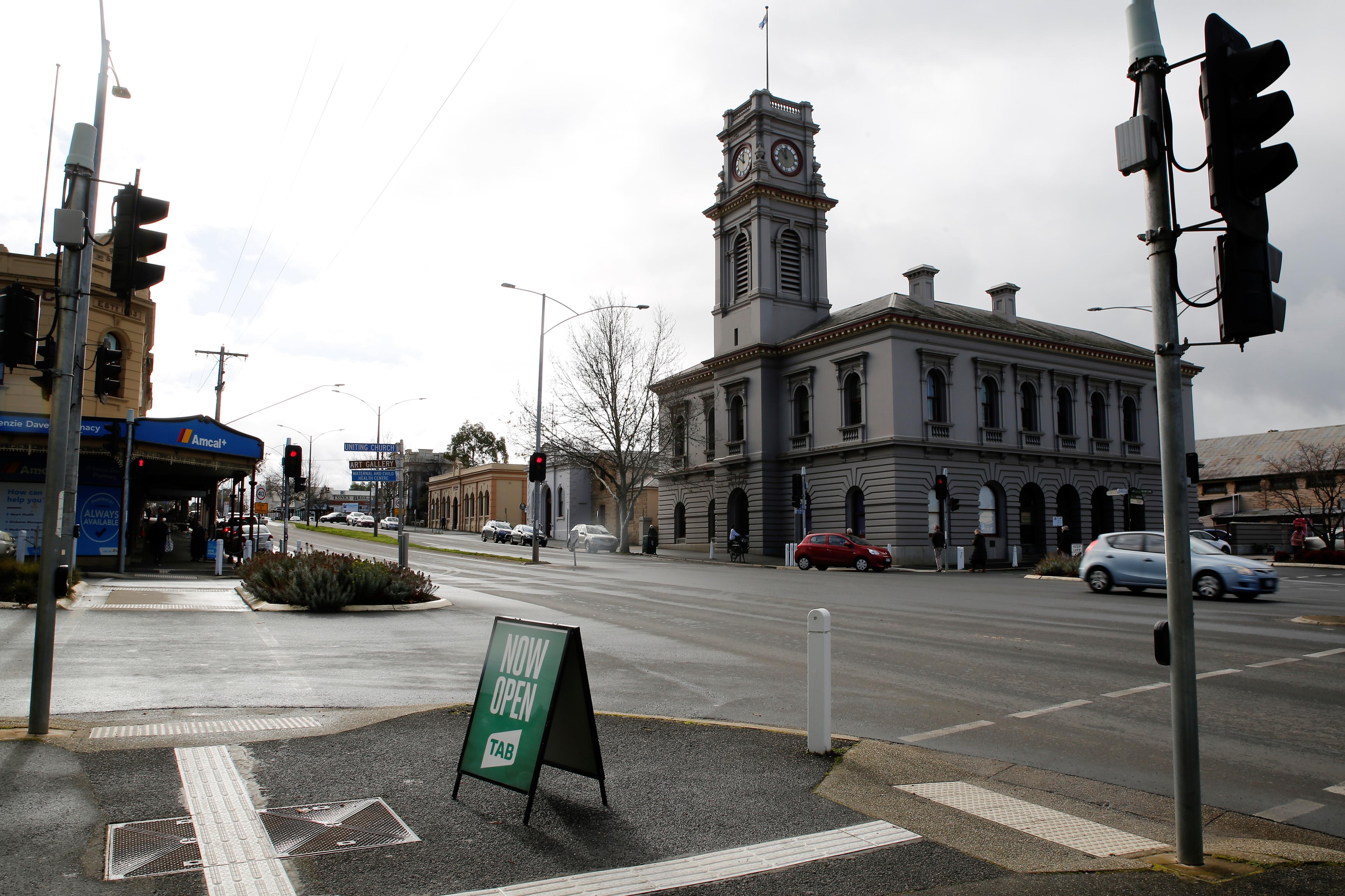 Main street of Castlemaine with old shops and traffic lights.