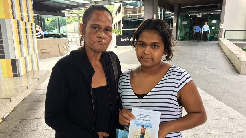 Sonya Coghill (left), sister of Shaun Charles Coolwell, stands outside court in Brisbane with another relative.