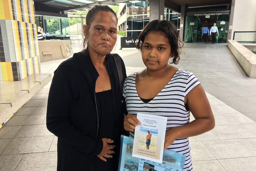 Sonya Coghill (left), sister of Shaun Charles Coolwell, stands outside court in Brisbane with another relative.