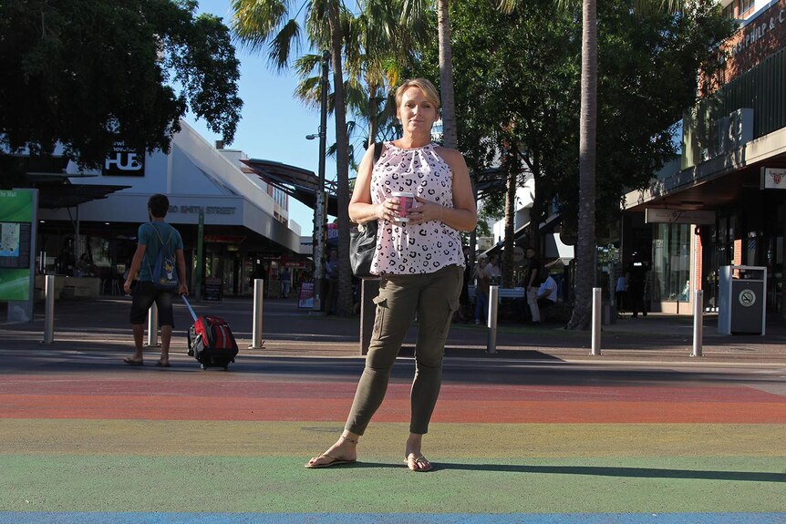 A photo of transgender woman Sianne Tate standing on Darwin's rainbow crossing.