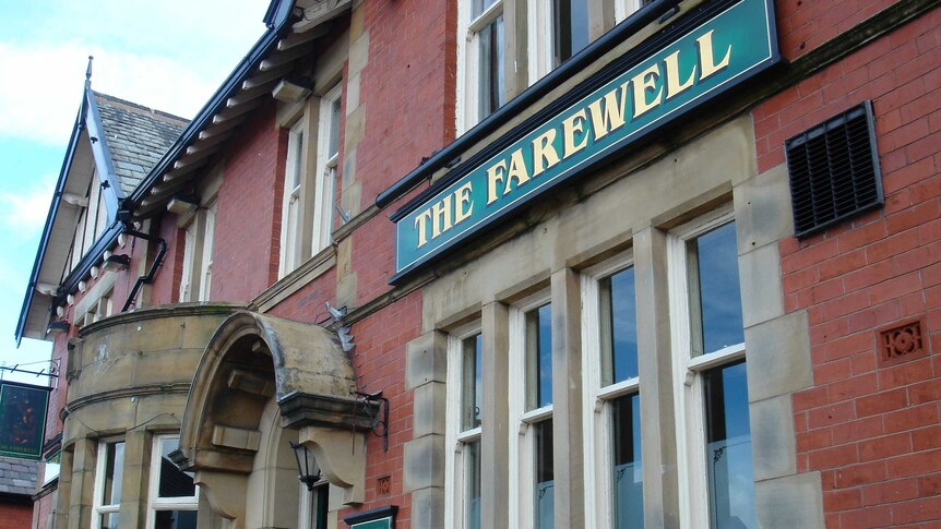 The exterior of a red brick pub with a green sign saying "the Farewell".