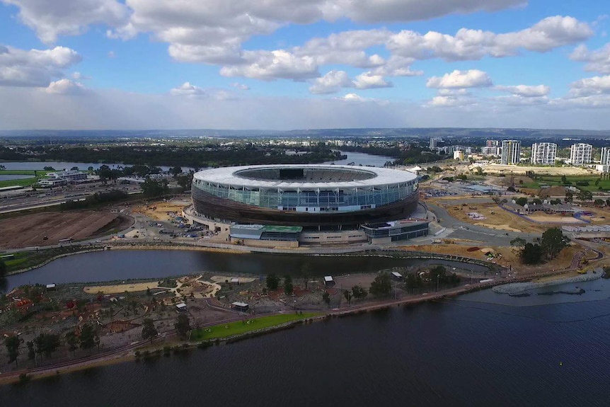 A wide shot of the new Perth Stadium taken from a drone flying above the Swan River.