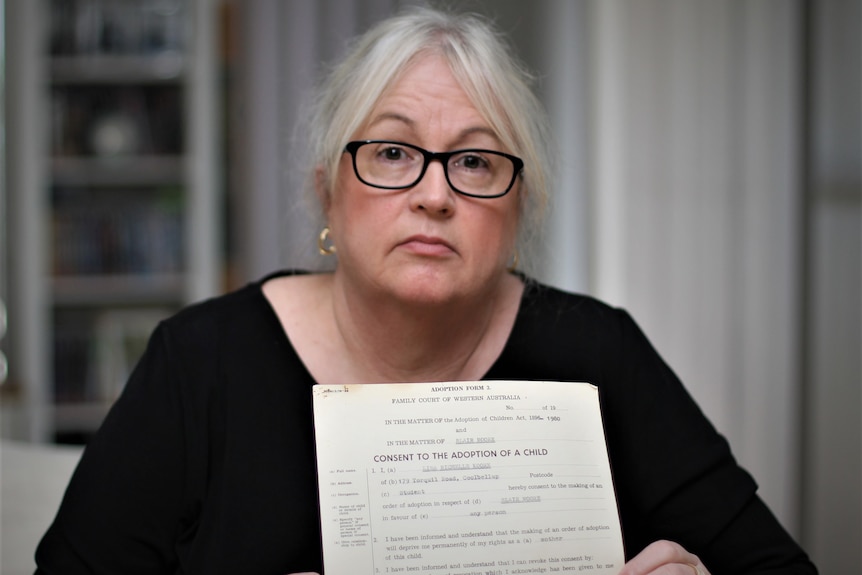 Lisa Moore holding adoption certificate