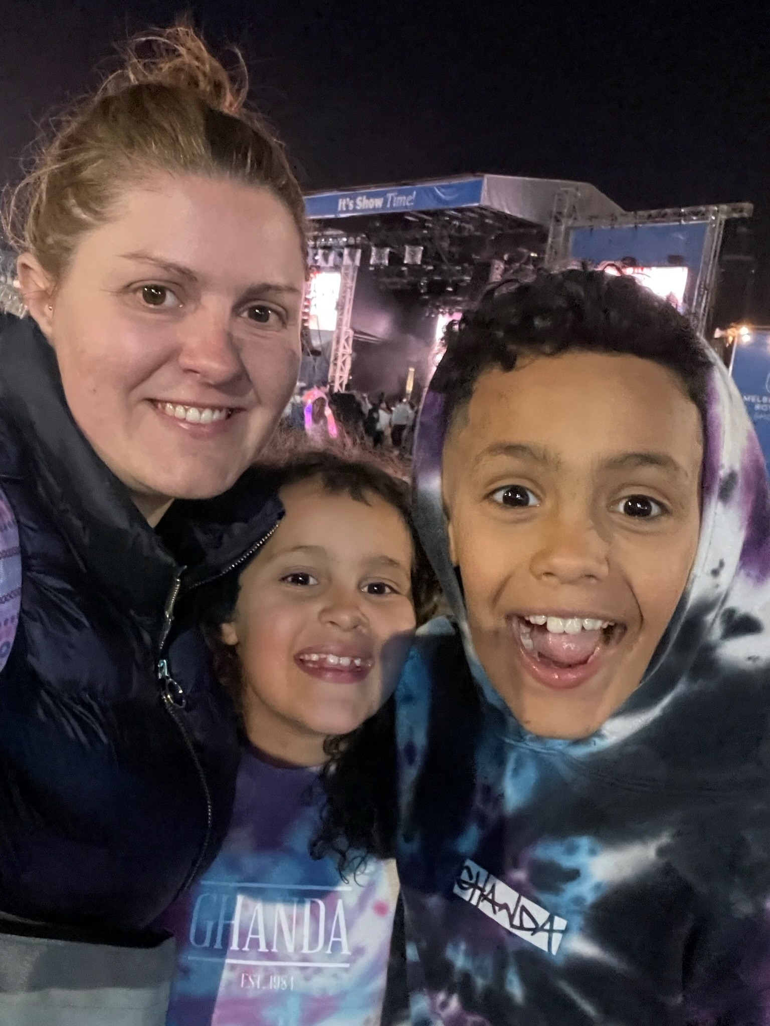 A woman and her two young children at the Royal Melbourne Show smiling into the camera.