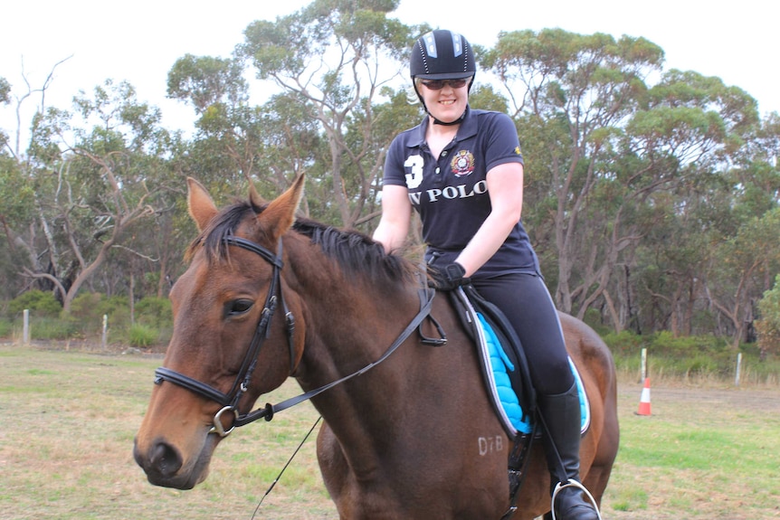 A photo of Naomi Ogden riding her horse.