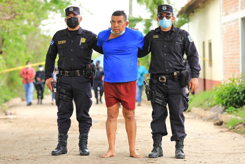 Former police officer Hugo Osorio Chávez Osorio is led away by police.