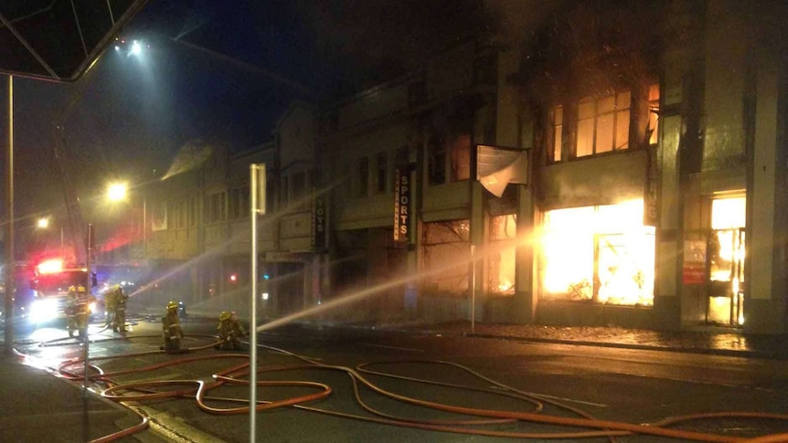 Fire crews train hoses on a shop blaze in Hobart's CBD