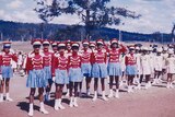 A group of Cherbourg marching girls dressed in red and blue uniforms in 1958, location unknown.