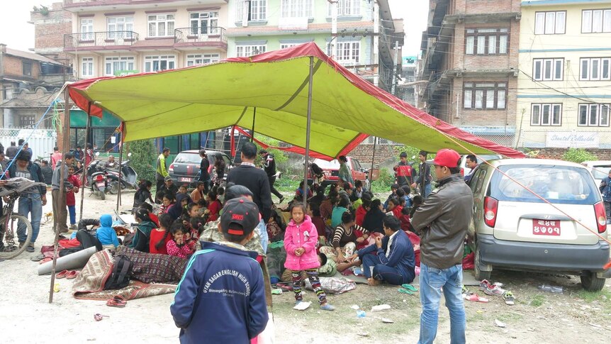 People camped on the grounds of a school in Nepal