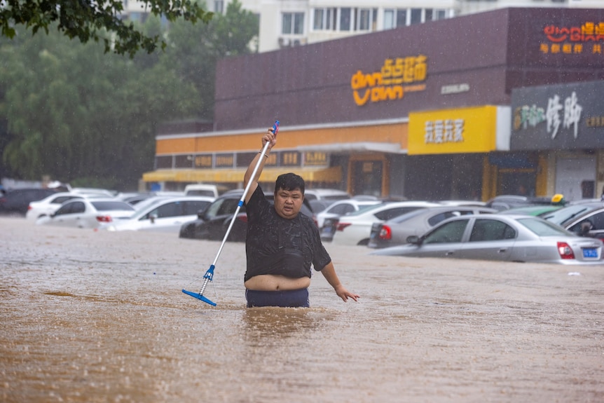 a man walking in flood in Beijing