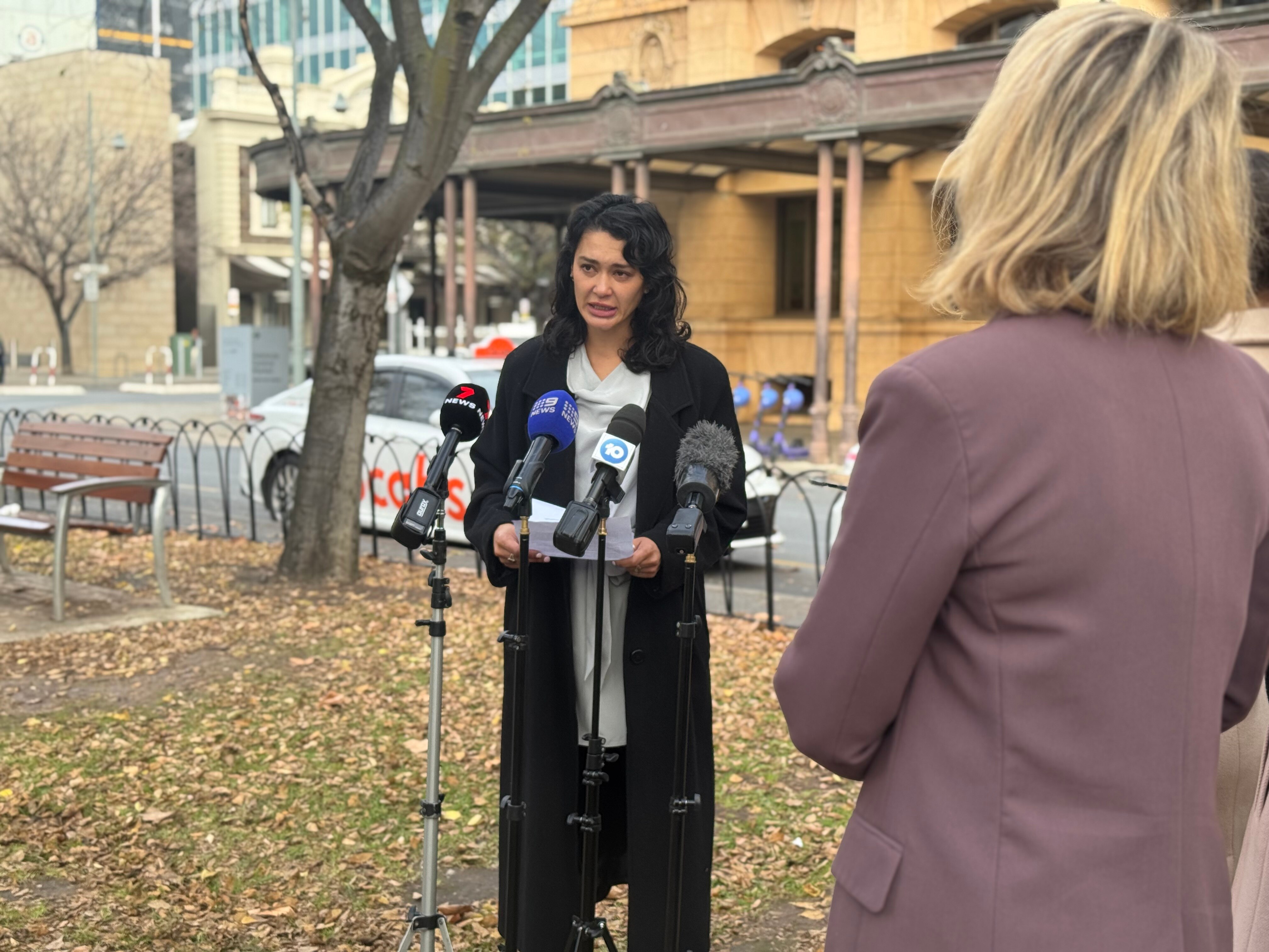A survivor reading a statement outside court.