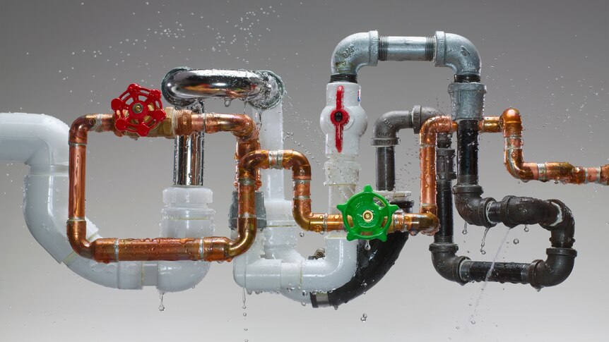 A set of multi-coloured pipes leaking water