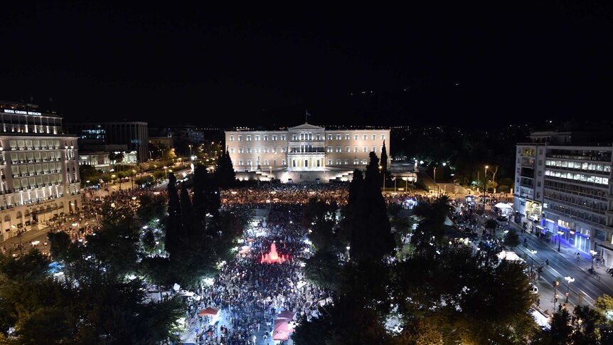 People gather in front of the Greek Parliament in Athens on July 5, 2015 to celebrate after early results lean towards a 'no' vote