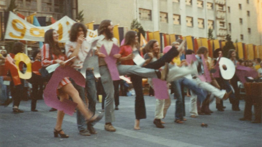 1972 Gay Liberation Movement at Melbourne City Square featuring a line of people with linked arms.