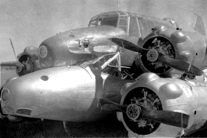 A black and white photo of two twin engine planes on top of each other.