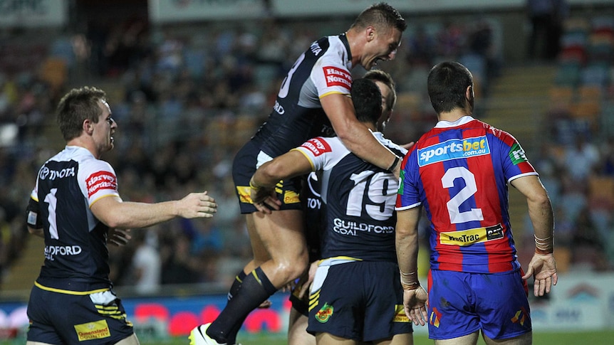 North Queensland Cowboys celebrate a try against the Newcastle Knights