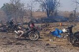 Charred remains of scooters and trees after an air strike.