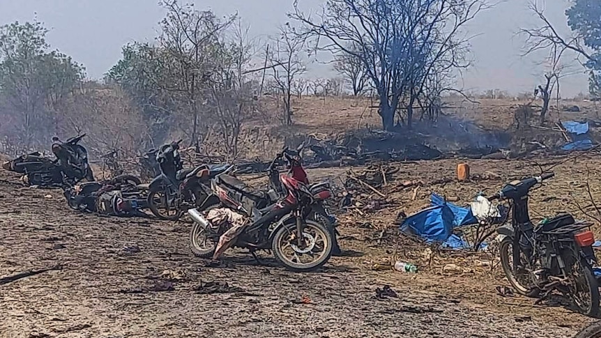 Charred remains of scooters and trees after an air strike.