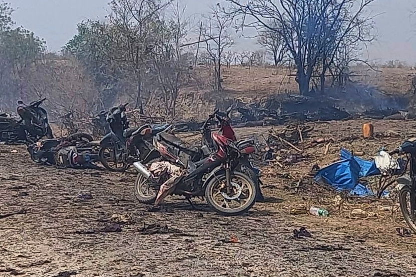 Charred remains of scooters and trees after an air strike.