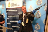 A policeman holds a gun
