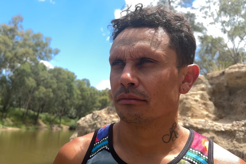 An indigenous man surveys the landscape