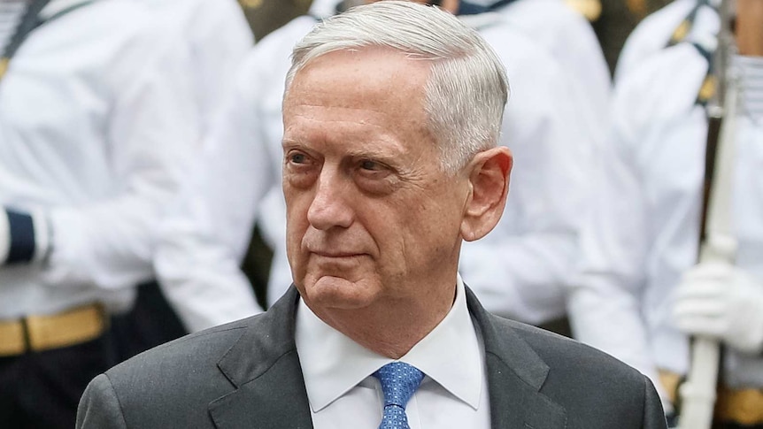 US Secretary of Defence James Mattis walks past honour guards standing to attention.