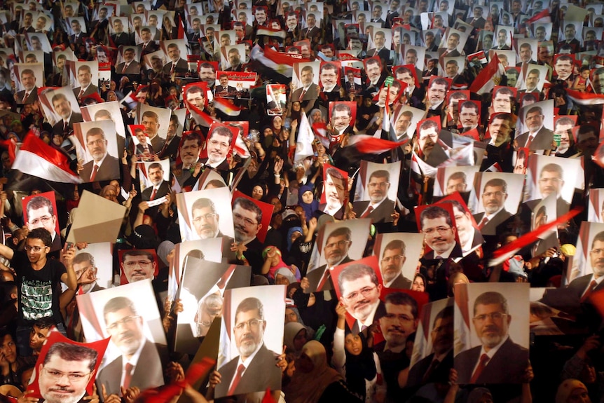 Supporters of Mohammed Morsi hold photos of Morsi in the Raba El-Adwyia mosque square, Cairo.