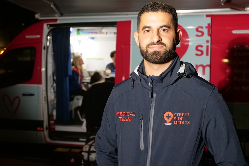 Medic Daniel Nour stands outside a van.