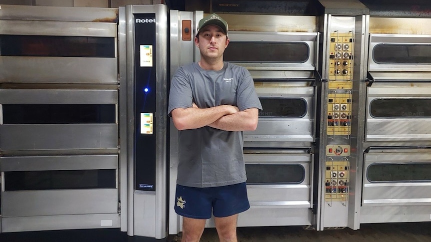 Queensland baker Cameron Boscacci in front of his industrial ovens.