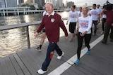 Prime Minister Kevin Rudd and his supporters go for an early morning walk beside the Brisbane River.