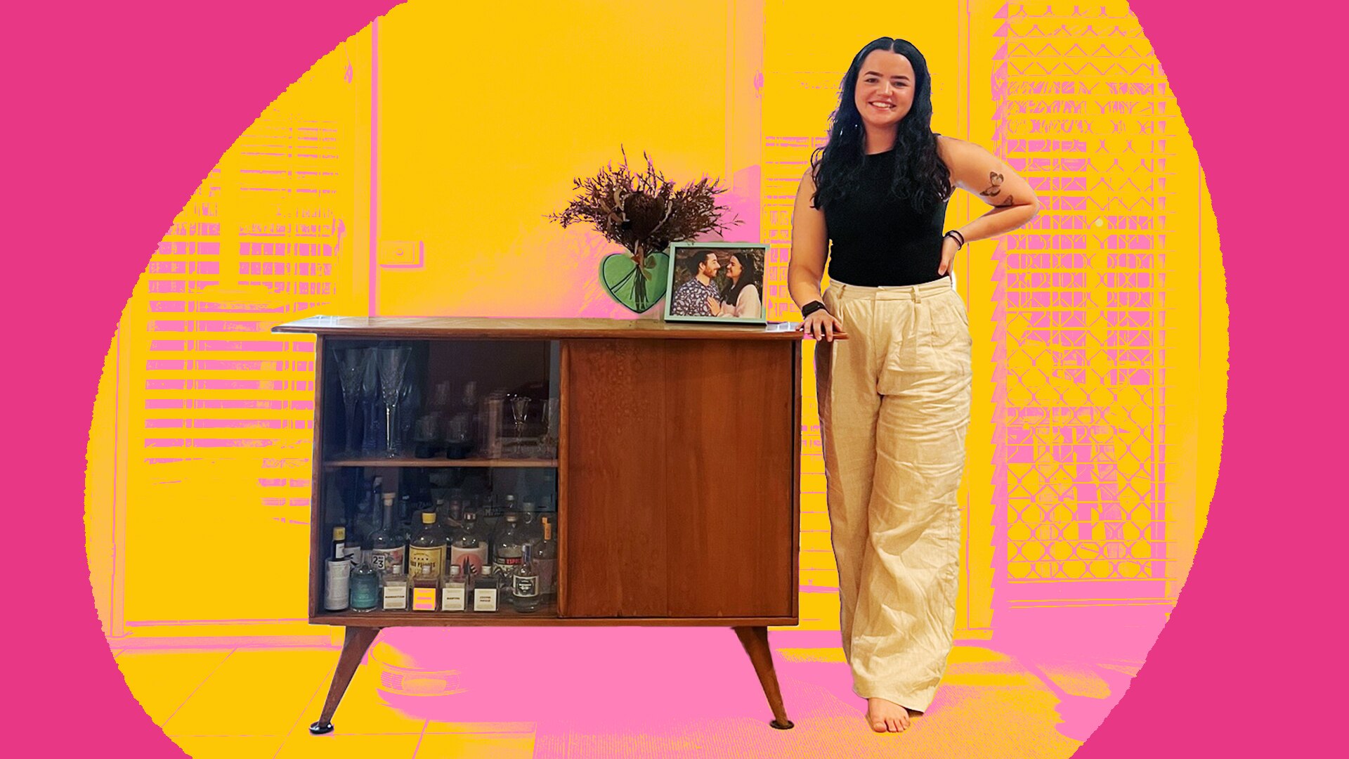 Camille stands next to her bar table