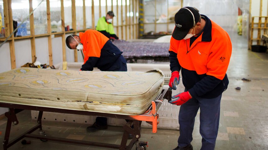 Staff working on mattresses at an existing project at Bellambi.