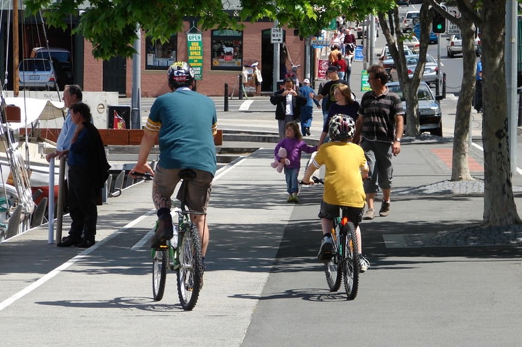 A man and a child cycle along Hobart's waterfront.