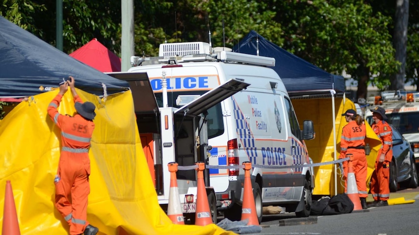 SES workers put up barriers to cover the scene of a deadly stabbing.