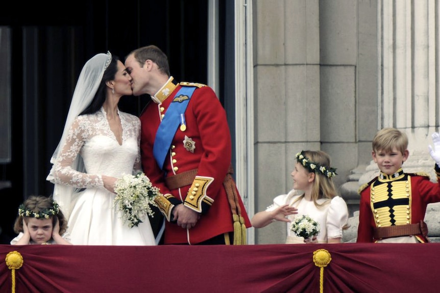 The Duke and Duchess of Cambridge kiss on the balcony of Buckingham Palace.
