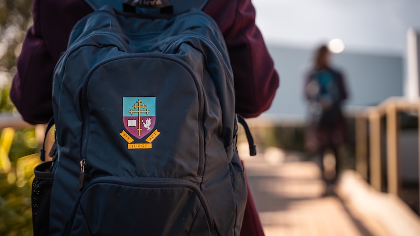 Close up of a Cardijn College school backpack.