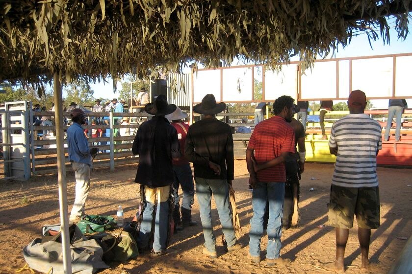 Aboriginal cowboys and locals look on at a rodeo at Doomadgee