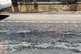 Melted road with a car on it.