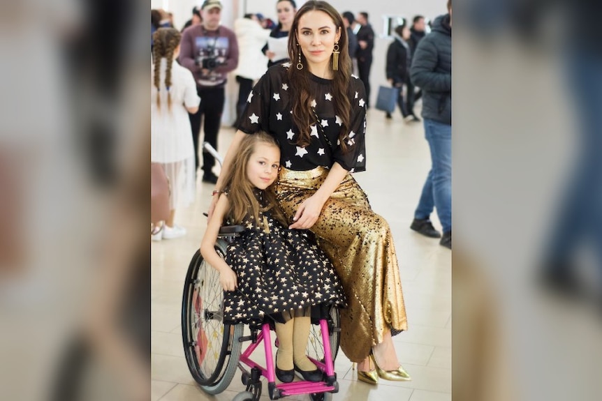 A mother pictured with he daughter in a wheelchair
