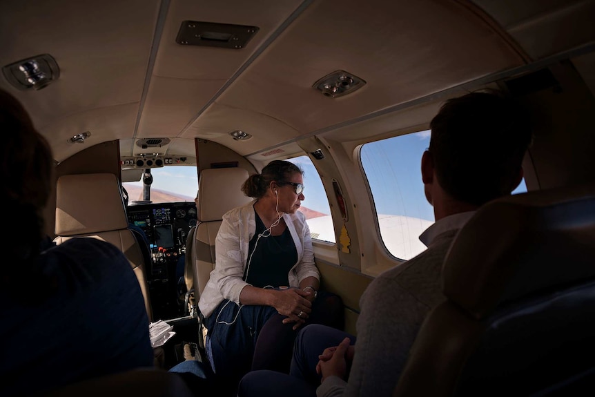 Leanne Liddle looks out the window of a charter plane.