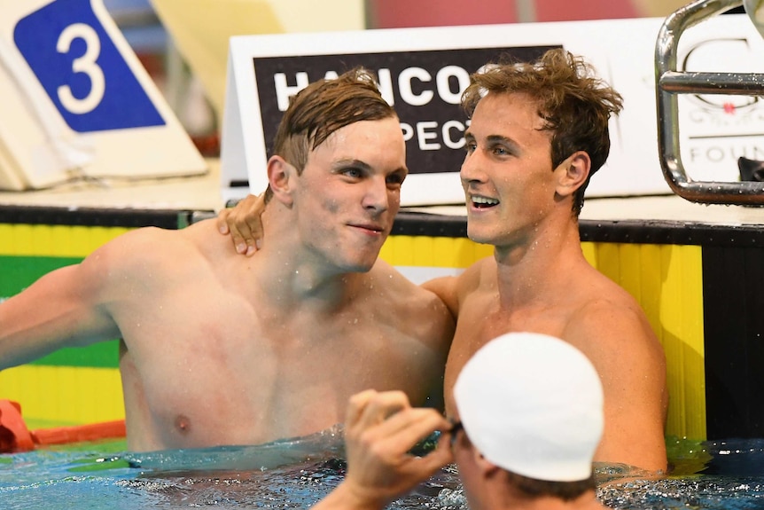 Cameron McEvoy puts his arm around Kyle Chalmers in the pool after a race win
