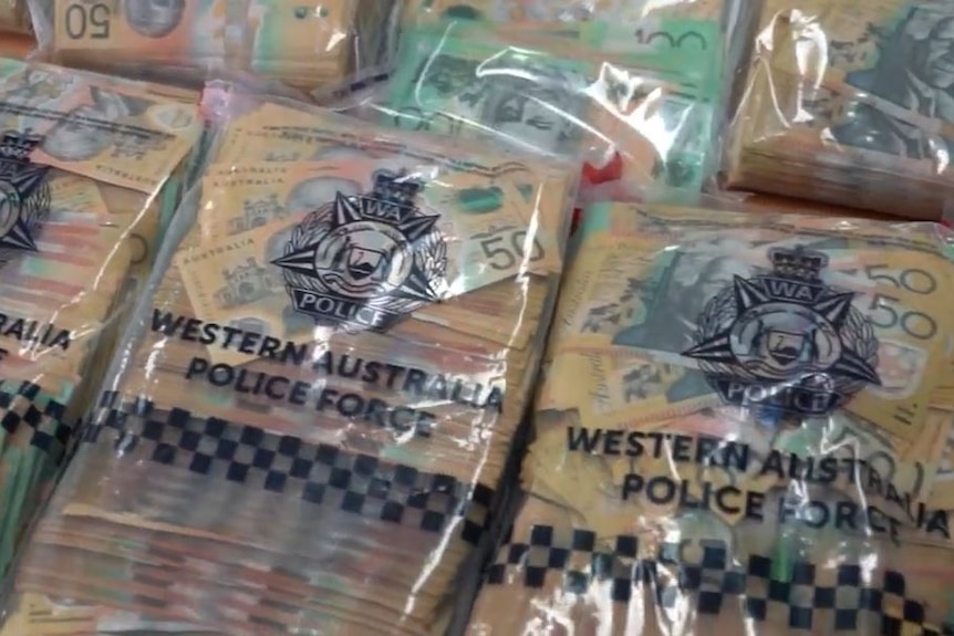 A WA Police logo on evidence bags containing large amounts of cash.  