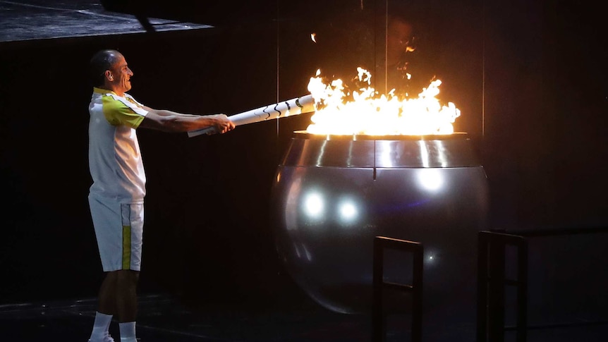 Vanderlei de Lima lights the Olympic flame