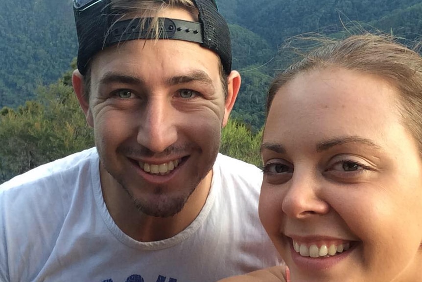 A young couple in a selfie-style photo, smiling.